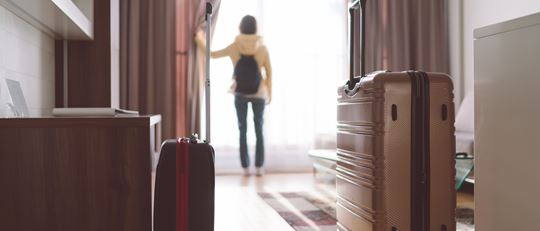 Woman is packed and ready to leave her Hotel Room