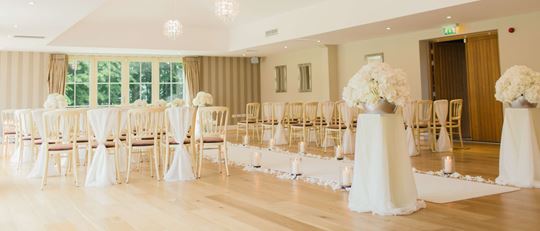 Wedding venue with decorated chairs and an alter